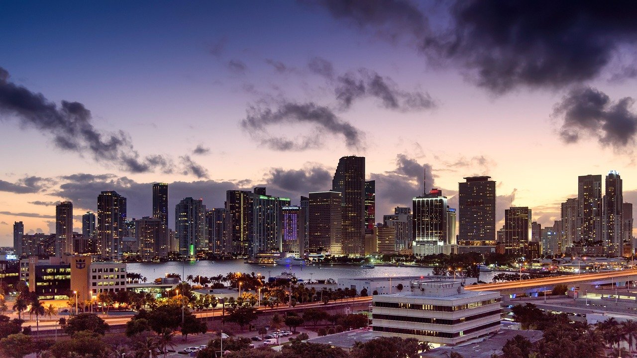 Why Moving to Florida is the Best Decision You Can Make miami, florida, sunset, skyline, architecture, scenery, cityscape, downtown, building, urban, sky, skyscraper, city, clouds, nature, tower, metropolis, scenic